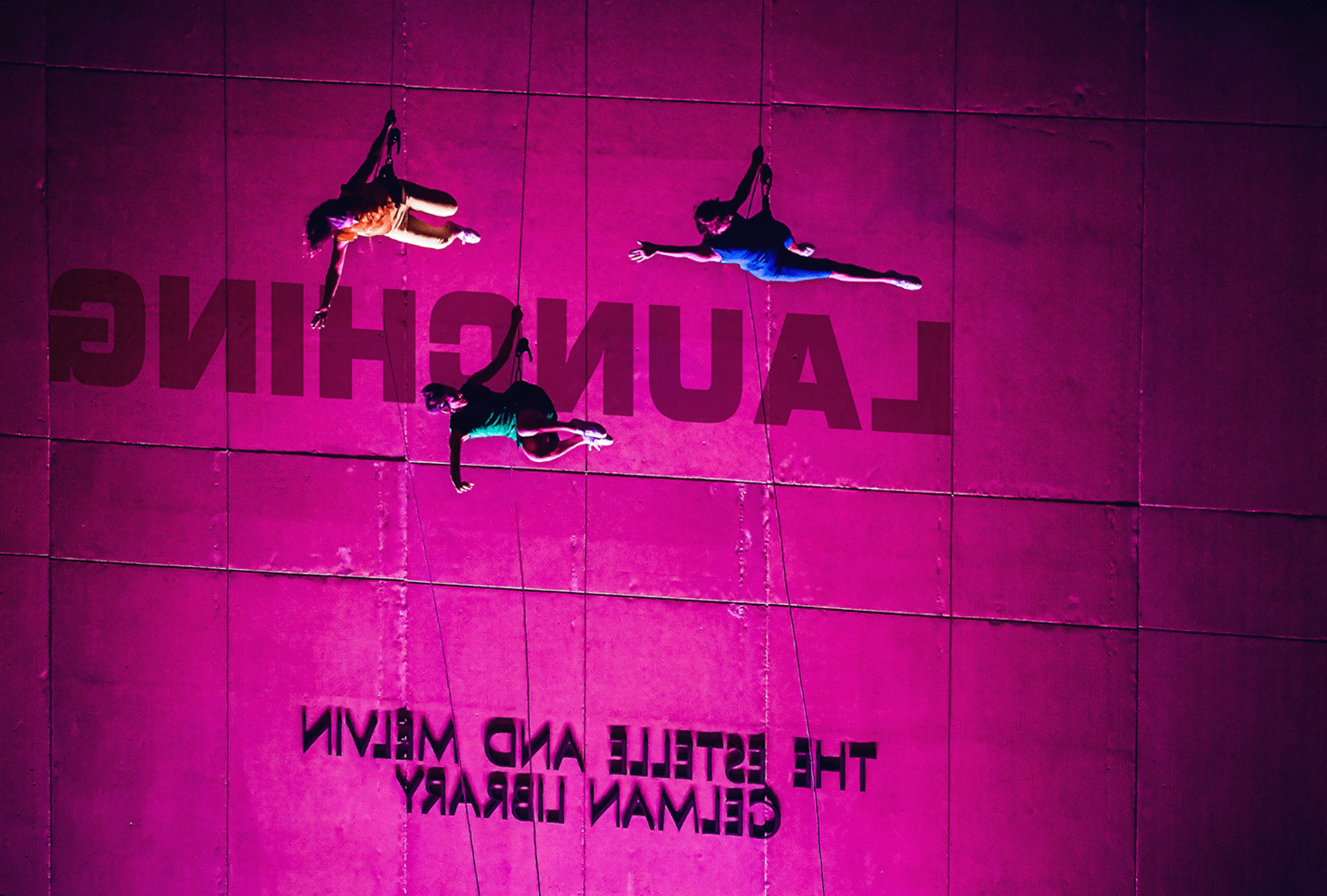 pink wall with trapeze artists